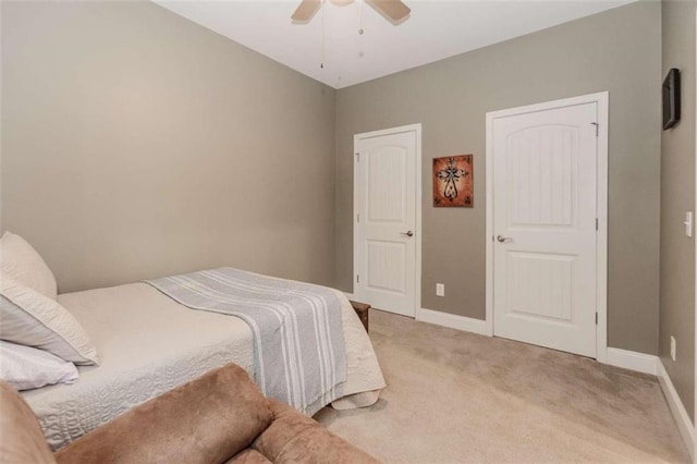 bedroom featuring ceiling fan and carpet