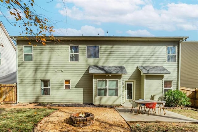 back of house with a fire pit and a patio area