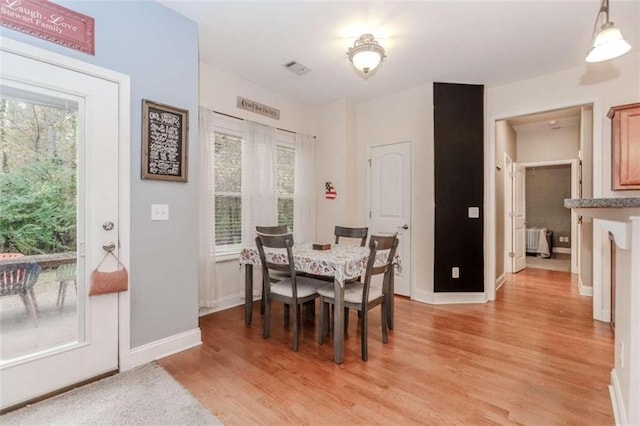 dining area with light hardwood / wood-style floors