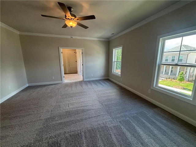 empty room featuring ornamental molding, baseboards, ceiling fan, and carpet flooring