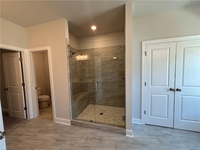 full bathroom featuring baseboards, a shower stall, toilet, and recessed lighting