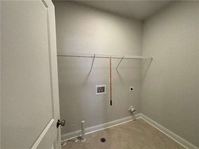 laundry room with hookup for a washing machine, hookup for an electric dryer, tile patterned flooring, and baseboards
