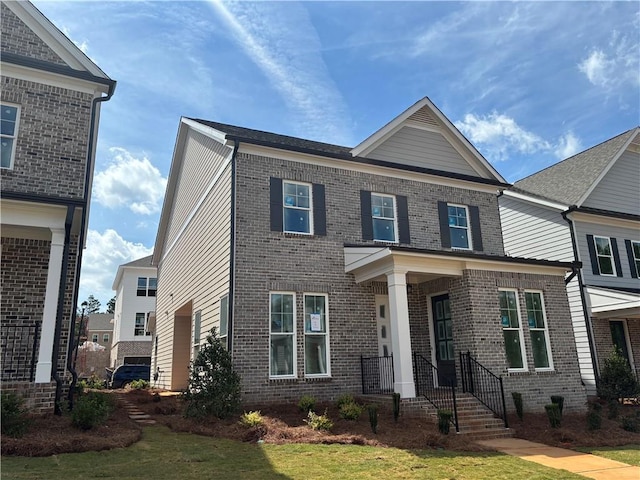 view of front of home with brick siding and a front lawn