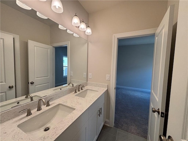 bathroom with tile patterned flooring, double vanity, and baseboards