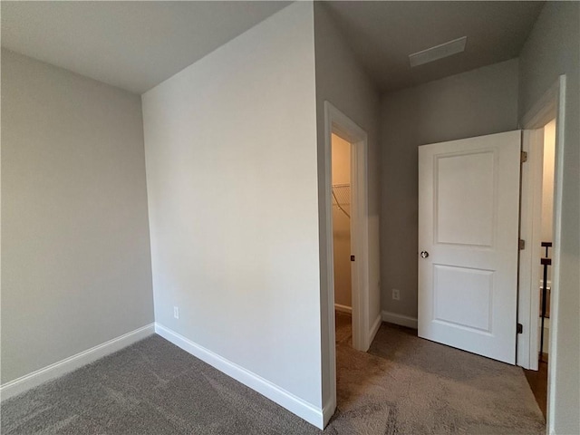 hallway featuring carpet floors and baseboards