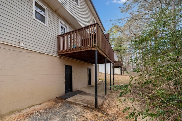 exterior space with a patio area and a wooden deck