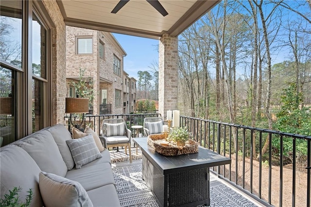 balcony with an outdoor living space and a ceiling fan