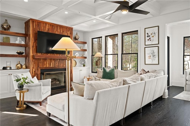 living room with coffered ceiling, dark wood-type flooring, a fireplace, recessed lighting, and ceiling fan