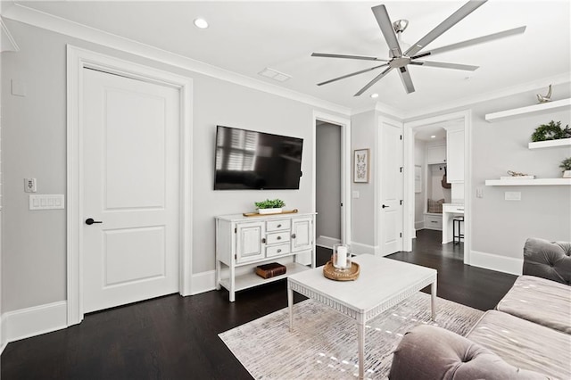 living room with dark wood finished floors, a ceiling fan, and ornamental molding