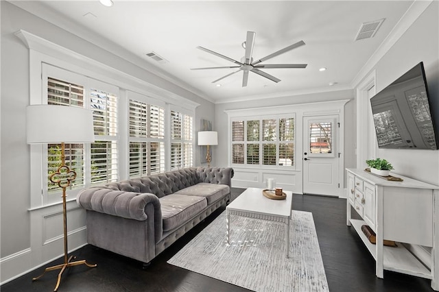 living room with ceiling fan, crown molding, dark wood-type flooring, recessed lighting, and a decorative wall