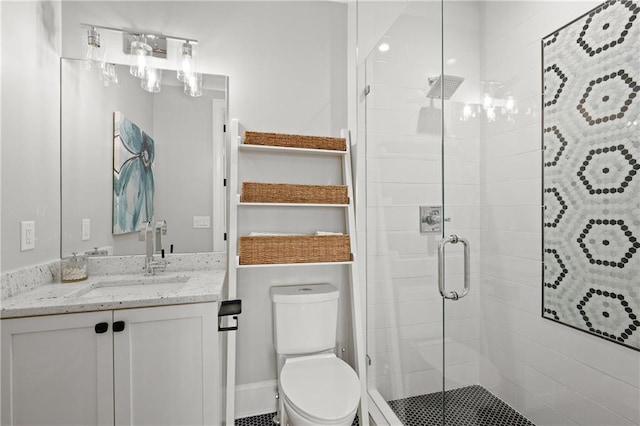 full bathroom with toilet, a stall shower, and vanity