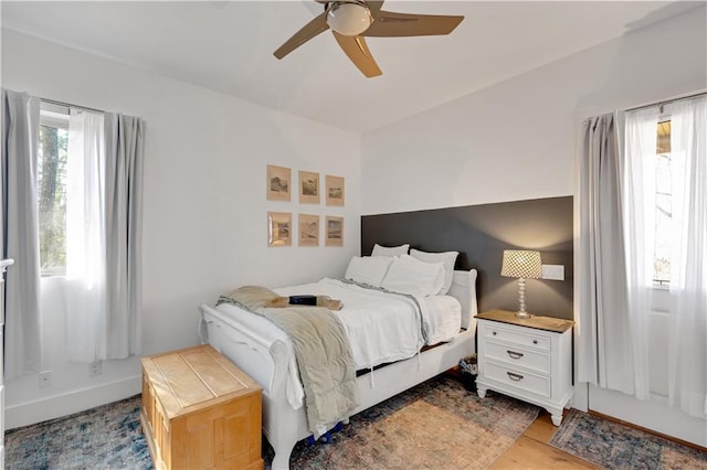 bedroom with ceiling fan and baseboards