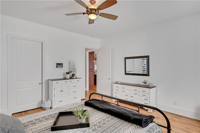 bedroom featuring light wood finished floors, ceiling fan, and baseboards