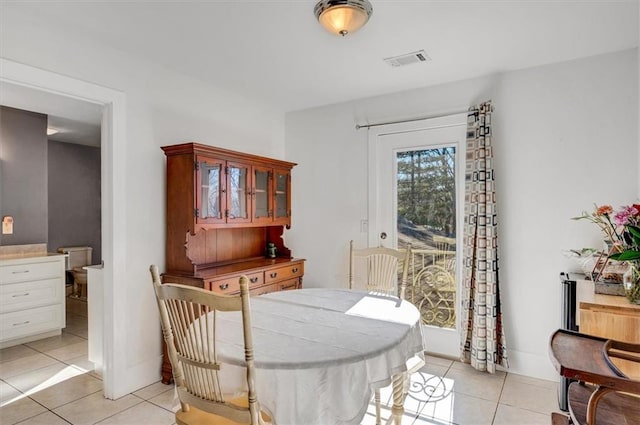 dining area featuring light tile patterned flooring and visible vents