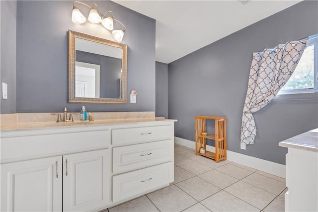 bathroom with tile patterned flooring, vanity, and baseboards