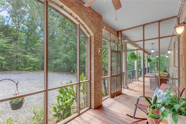 sunroom featuring ceiling fan