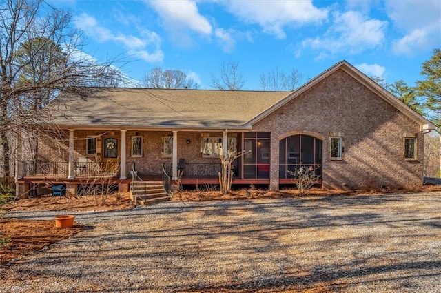 back of property featuring a porch and a sunroom