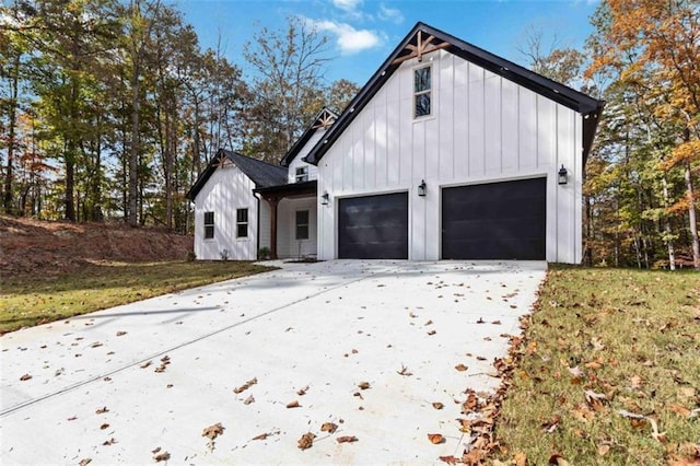 exterior space with a garage, driveway, and board and batten siding