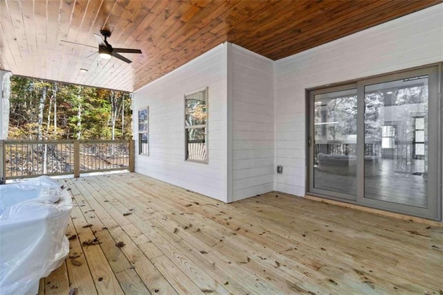 wooden deck with a grill and ceiling fan