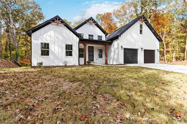 modern inspired farmhouse with board and batten siding, concrete driveway, and a front lawn