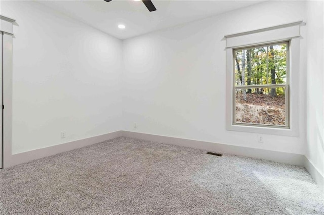 carpeted empty room with a ceiling fan, recessed lighting, visible vents, and baseboards