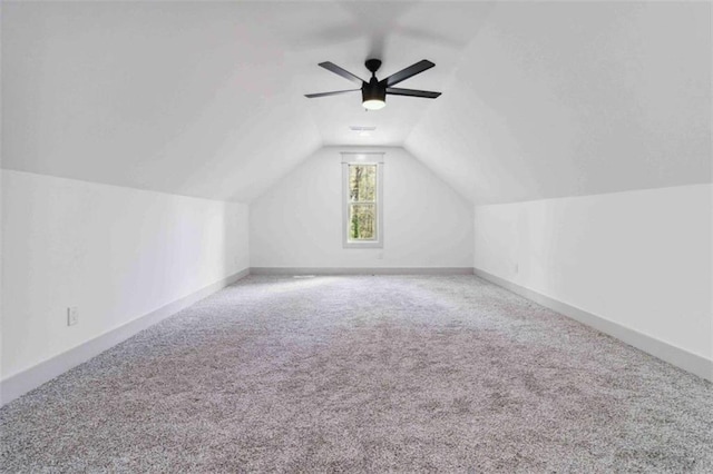 additional living space with lofted ceiling, carpet floors, ceiling fan, and baseboards