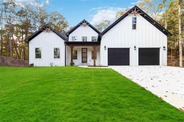 modern inspired farmhouse with board and batten siding, a garage, driveway, and a front lawn