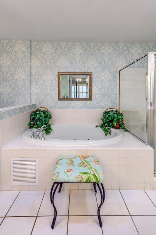 interior space with tile patterned floors and a relaxing tiled tub