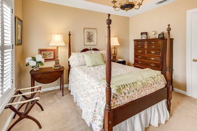 bedroom featuring a chandelier and light colored carpet