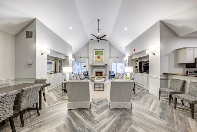 living room featuring ceiling fan, high vaulted ceiling, and light parquet flooring