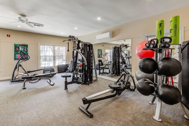 exercise room featuring a wall mounted AC and ceiling fan