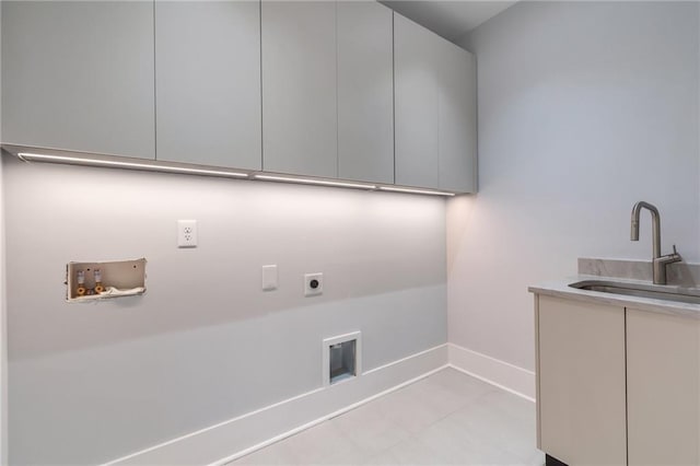 laundry room with hookup for a washing machine, baseboards, cabinet space, a sink, and electric dryer hookup