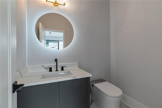 half bathroom with toilet and vanity