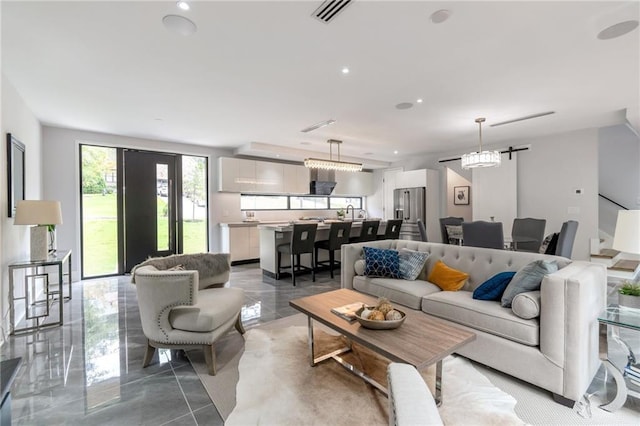 living area featuring recessed lighting and visible vents