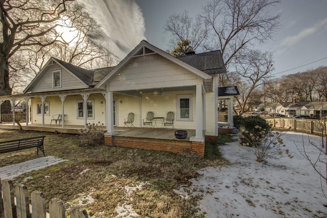 snow covered house with covered porch