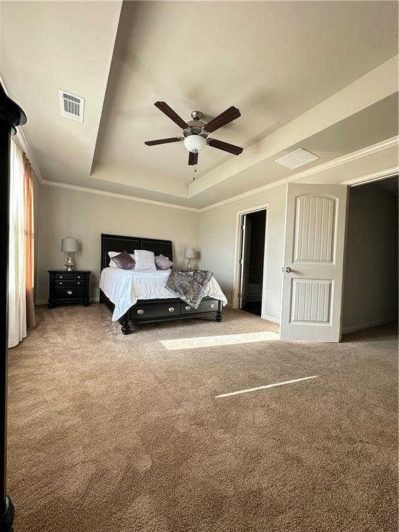 302 Turtle Creek Dr, Winder, GA 30680 - bedroom featuring a tray ceiling, carpet flooring, ceiling fan, and baseboards