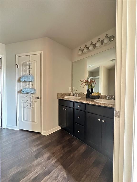 302 Turtle Creek Dr, Winder, GA 30680 - bathroom with wood finished floors, double vanity, and baseboards