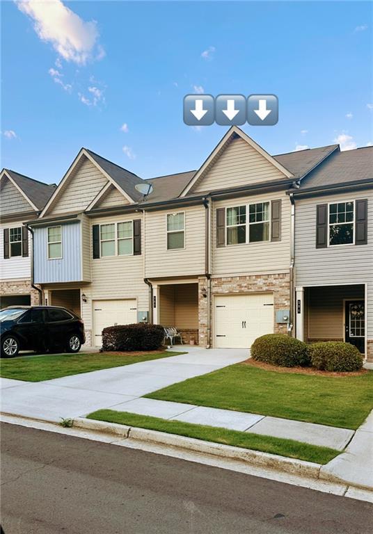 302 Turtle Creek Dr, Winder, GA 30680 - view of property with an attached garage, driveway, and a front lawn
