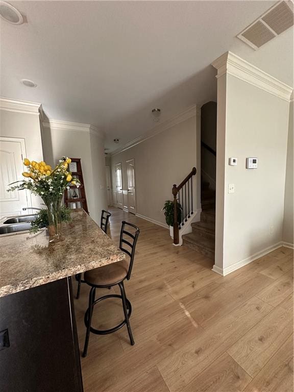 302 Turtle Creek Dr, Winder, GA 30680 - dining space featuring baseboards, light wood-style flooring, ornamental molding, and stairs
