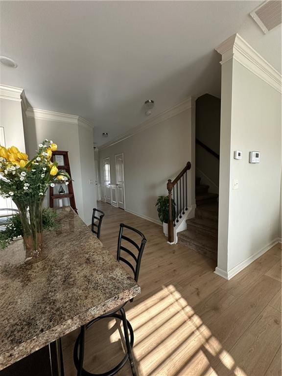302 Turtle Creek Dr, Winder, GA 30680 - dining space with wood finished floors, baseboards, crown molding, and stairs
