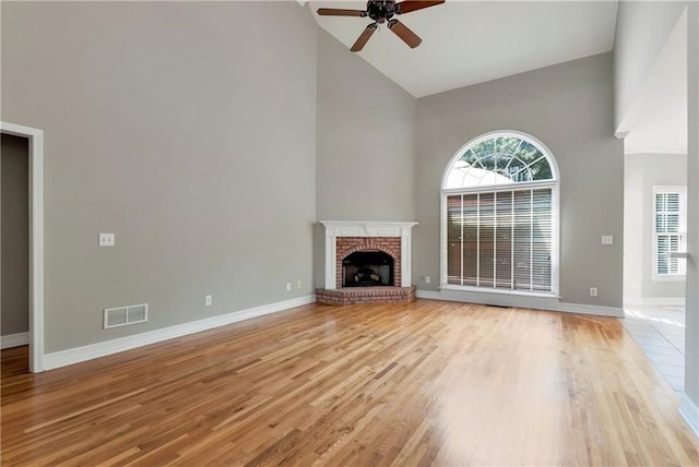 3885 Lake Juliette Dr, Buford, GA 30519 - unfurnished living room with high vaulted ceiling, ceiling fan, baseboards, and a fireplace