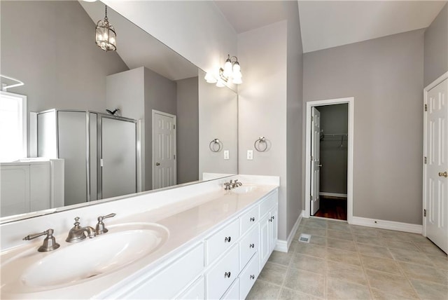 3885 Lake Juliette Dr, Buford, GA 30519 - full bath featuring a stall shower, double vanity, lofted ceiling, baseboards, and a walk in closet
