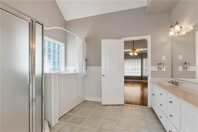 3885 Lake Juliette Dr, Buford, GA 30519 - bathroom featuring a stall shower, healthy amount of natural light, tile patterned floors, vanity, and vaulted ceiling