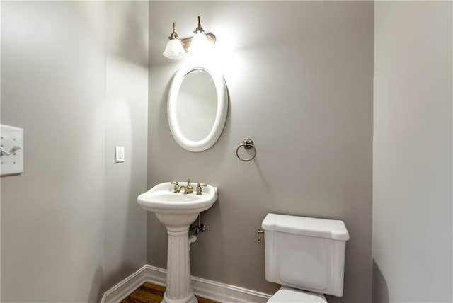 3885 Lake Juliette Dr, Buford, GA 30519 - bathroom featuring toilet, baseboards, wood finished floors, and a sink