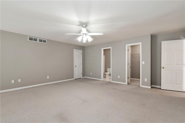 3885 Lake Juliette Dr, Buford, GA 30519 - unfurnished bedroom with baseboards, light carpet, ensuite bathroom, a spacious closet, and ceiling fan