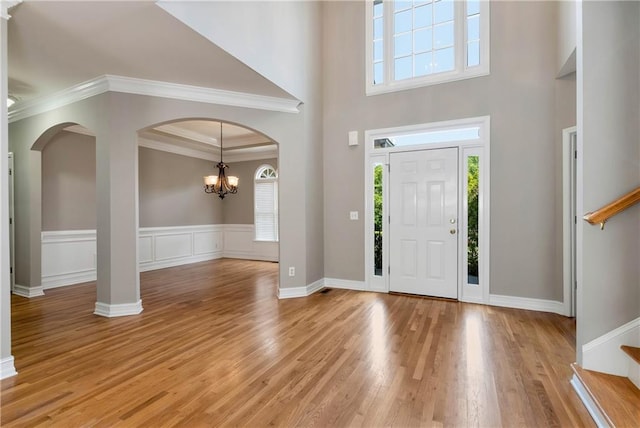 3885 Lake Juliette Dr, Buford, GA 30519 - entrance foyer featuring stairs, arched walkways, plenty of natural light, a towering ceiling, and ornamental molding