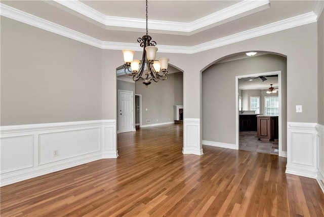 3885 Lake Juliette Dr, Buford, GA 30519 - unfurnished room featuring arched walkways, ceiling fan, a chandelier, wood finished floors, and a raised ceiling
