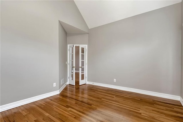 3885 Lake Juliette Dr, Buford, GA 30519 - spare room with baseboards, wood finished floors, french doors, and high vaulted ceiling