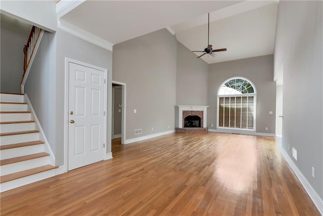 3885 Lake Juliette Dr, Buford, GA 30519 - unfurnished living room with a ceiling fan, light wood-style flooring, stairway, a high ceiling, and baseboards