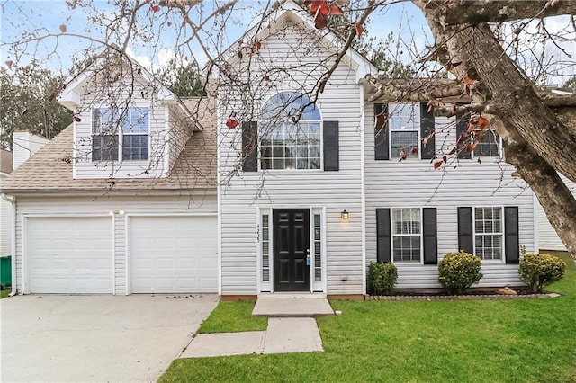 view of front of property with a front lawn and a garage